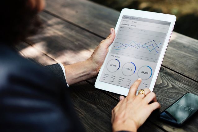 A businesswoman using software on a tablet devices